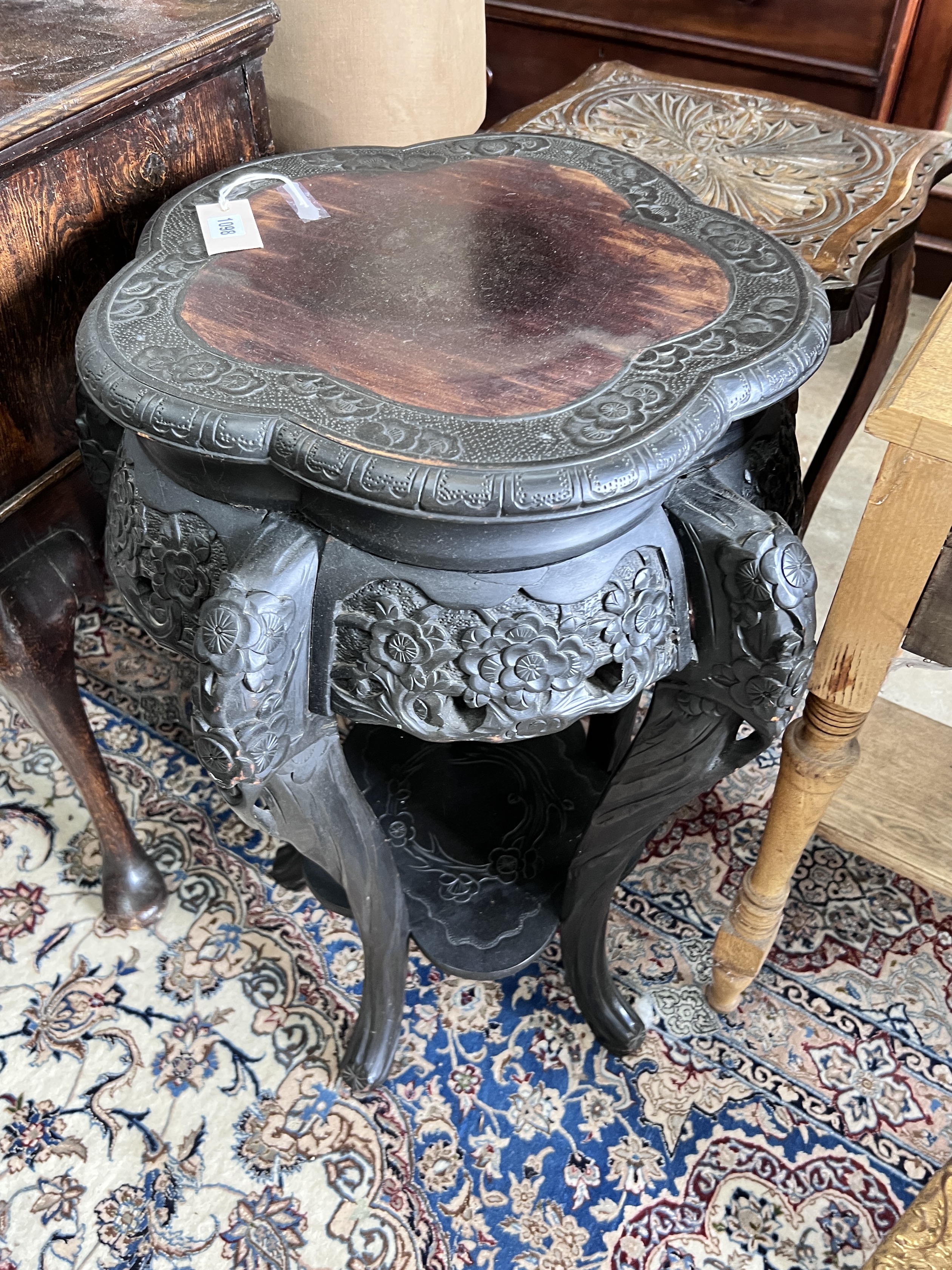 A Chinese carved two tier jardiniere stand, width 54cm, height 78cm, together with a carved beech oak two tier occasional table